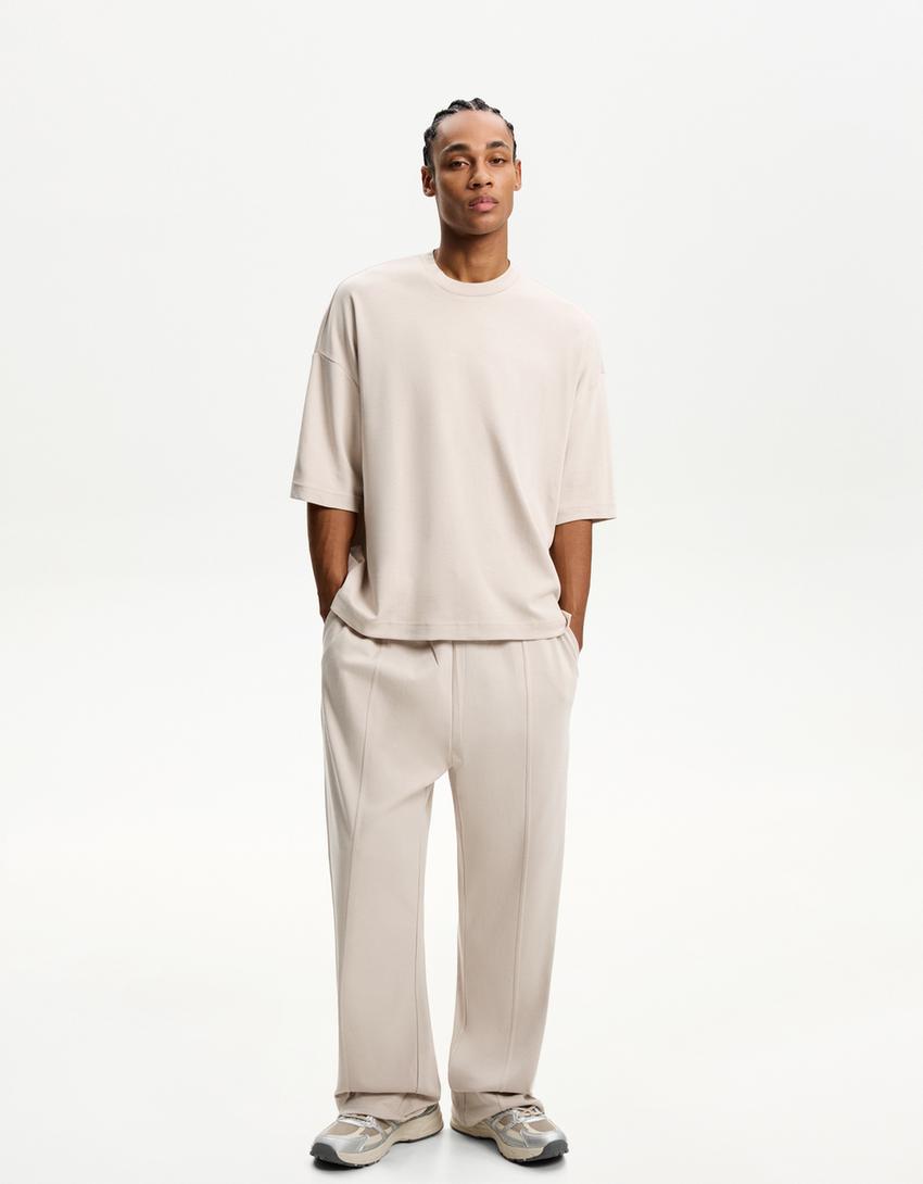 BERSHKA BAGGY TROUSERS IN BEIGE