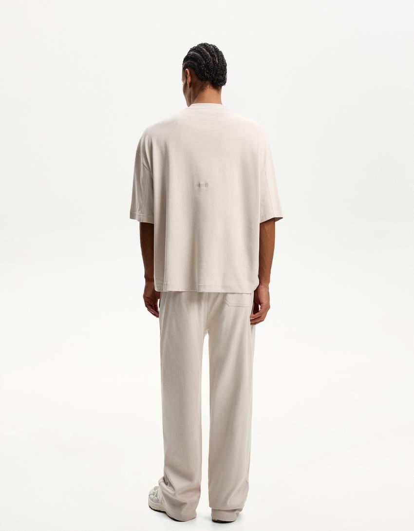 BERSHKA BAGGY TROUSERS IN BEIGE