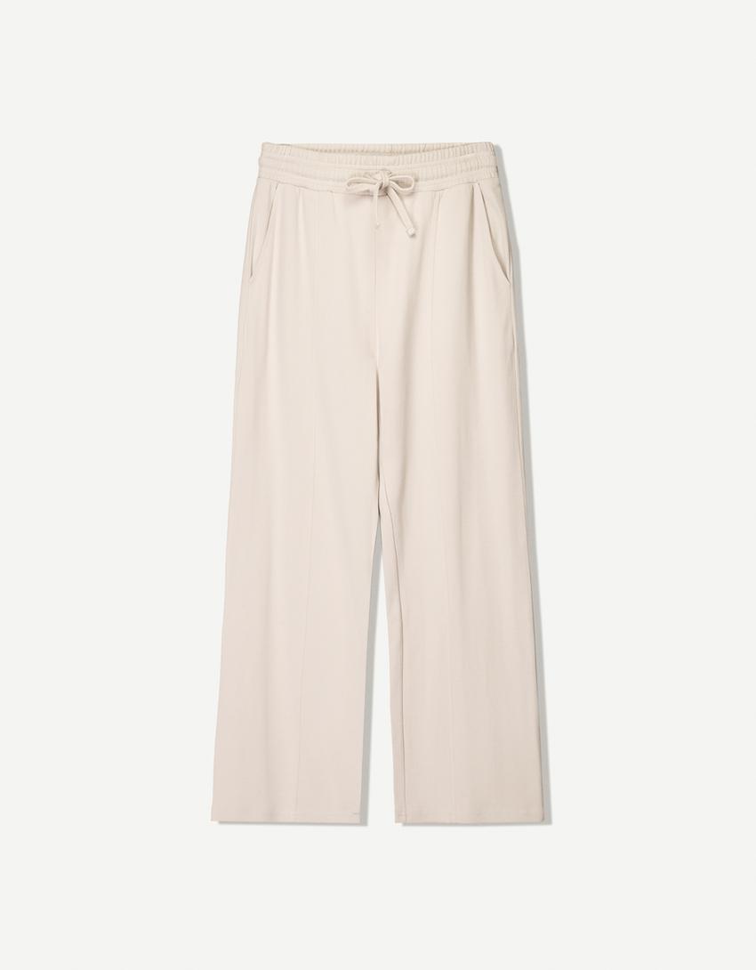 BERSHKA BAGGY TROUSERS IN BEIGE